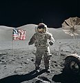A man standing on the moon with an American flag in the background (from Human history)