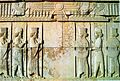 Stone relief depicting two groups of three men facing each other (from Human history)