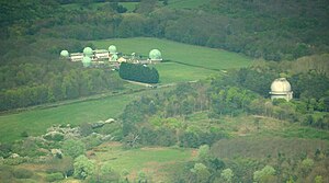 Aerial view of the Royal Greenwich Observatory, Herstmonceux site in East Sussex; the dome that formerly housed the Isaac Newton Telescope is the single dome to the right. The telescope was moved to La Palma in the Canary Isles in 1979.