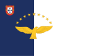 Blue and white bands, superimposed by golden goshawk and surmounted by nine stars with traditional Portuguese shield in the left corner.