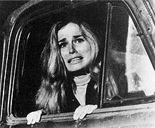 Judy peers from an open truck window.