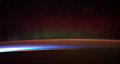 Image 21Earth's night-side upper atmosphere appearing from the bottom as bands of afterglow illuminating the troposphere in orange with silhouettes of clouds, and the stratosphere in white and blue. Next the mesosphere (pink area) extends to the orange and faintly green line of the lowest airglow, at about one hundred kilometers at the edge of space and the lower edge of the thermosphere (invisible). Continuing with green and red bands of aurorae stretching over several hundred kilometers. (from Earth)