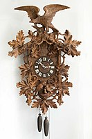 Carved wall timepiece, weight-driven, Black Forest, ca. 1900. Carved cuckoo clocks evolved from the Bahnhäusle style (Deutsches Uhrenmuseum, Inv. 2006–015)