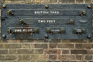 Imperial standard lengths on the wall of the Royal Observatory, Greenwich, London – 1 yard (3 feet), 2 feet, 1 foot, 6 inches (1/2-foot), and 3 inches. The separation of the inside faces of the marks is exact at an ambient temperature of 60 °F (16 °C) and a rod of the correct measure, resting on the pins, will fit snugly between them.[68][69]