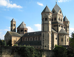 A large rectangular stone church with six towers