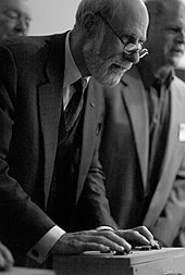 Vint Cerf leaning over a controller on a table