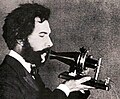 Image 49Actor portraying Alexander Graham Bell in a 1932 silent film. Shows Bell's second telephone transmitter (microphone), invented 1876 and first displayed at the Centennial Exposition, Philadelphia. (from History of the telephone)