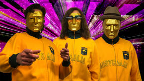 a screenshot of a music video showing three people wearing masks and Australia sweatshirts