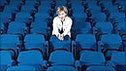 Woman sitting alone in a theatre