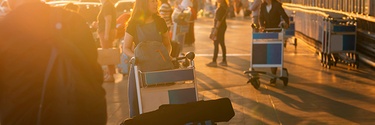 web_Women-with-luggage-trolleyat-sunrise_credit_Shine-Nucha_shutterstock_1210915450.jpg