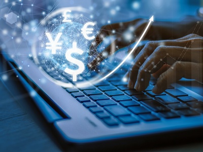Laptop with currencies 13 Phunkod shutterstock 1421006570 - Credit: 13 Phunkod shutterstock - 1421006570