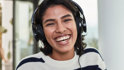 A gamer smiling and wearing headphones