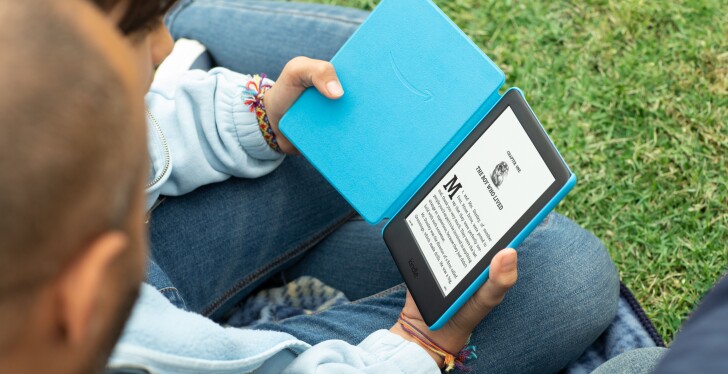 A child reads a Kindle