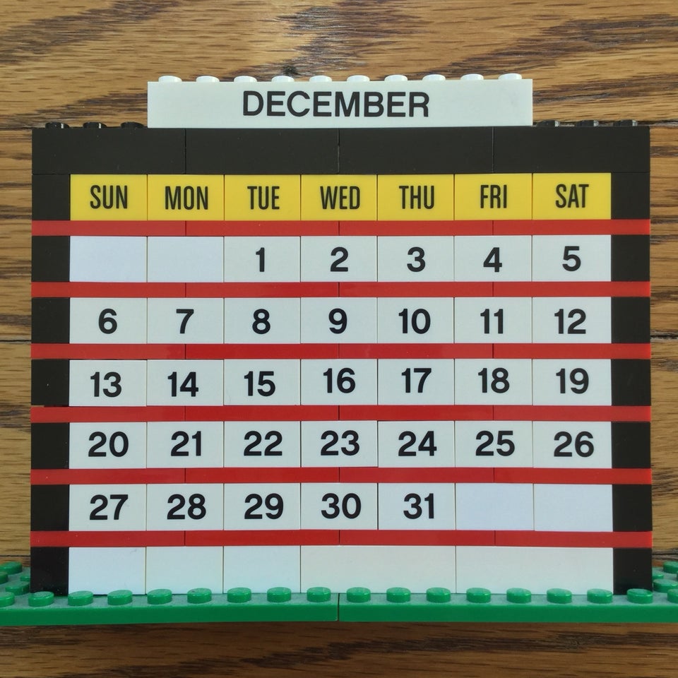 December of 2020 month calendar built from LEGO bricks, on an hardwood floor background.