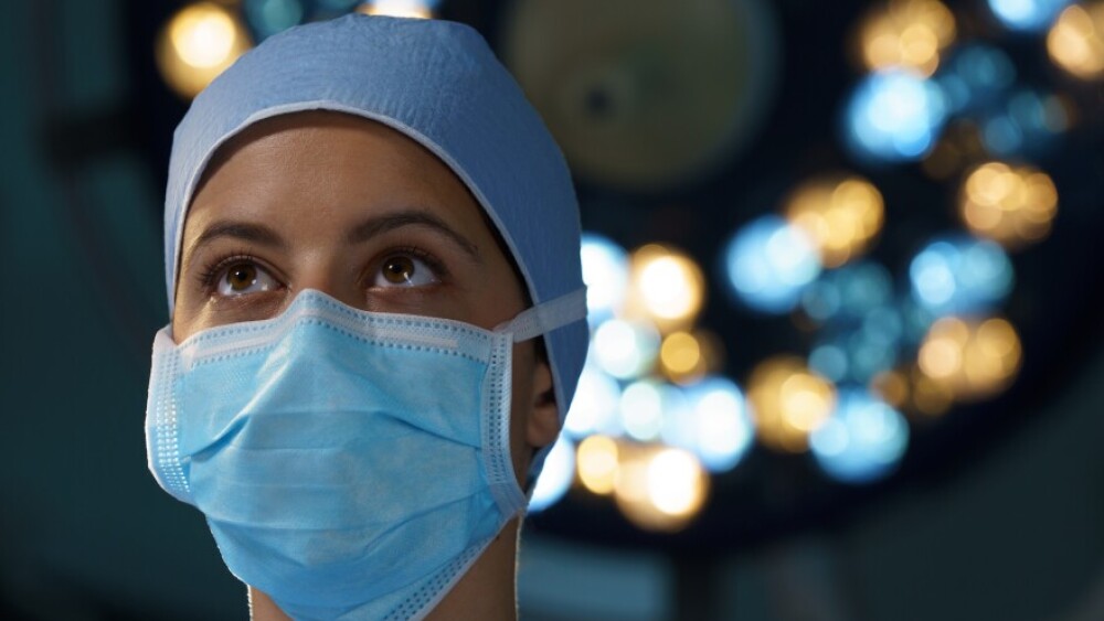 A healthcare professional in full PPE standing in the OR 