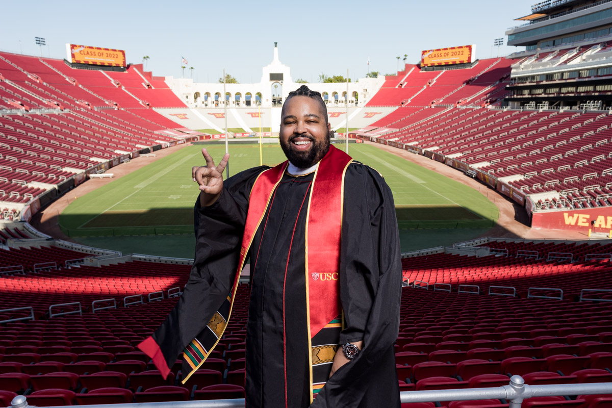 Photo of Cordell graduating from USC in the football stadium.