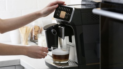 Hands using espresso machine.