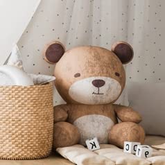 Baby nursery with crib and teddy bear