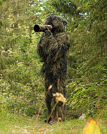 Wildlife Photographer Giles Laurent in a ghillie suit