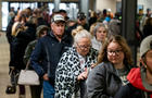 People wait in line at the Norfolk Southern Assistance Center to collect a $1000 check and get reimbursed for expenses on Feb. 17, 2023, in East Palestine, Ohio. 