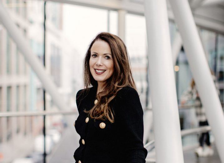A woman wearing a dark coat smiles in front of an office building. She is Vanessa Hartley, Google Ireland's new head of operations.
